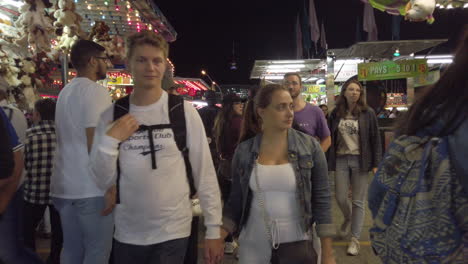 People-walking-around-and-playing-carnival-games-at-night