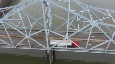 4K-Aerial-Red-Truck-Driver-on-bridge-over-river