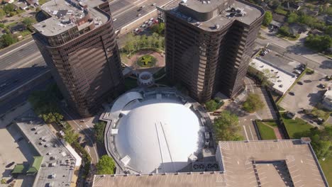 Aerial-view-overlooking-the-Arena-Theatre,-in-sunny-Houston,-USA---high-angle,-orbit,-drone-shot