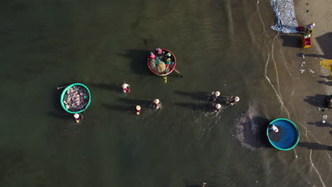 Aerial-top-view-of-people-in-the-sea-loading-trucks-and-cleaning-boat