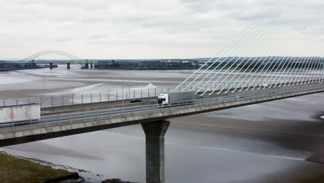 Mersey-gateway-landmark-aerial-view-above-toll-suspension-bridge-river-crossing-low-tracking-right-shot