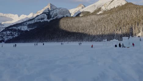 Tracking-shot-people-having-fun-at-frozen-lake-Louise