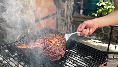 slow-motion-scene-of-meat-being-cut-ready-to-be-removed-from-the-grill-with-a-fork