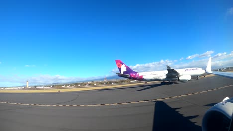 Hawaiian-Airlines-commercial-flight-arriving-with-passengers-at-the-Kahului-Airport-in-MAUI