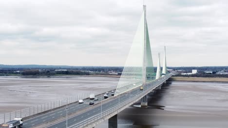 Mersey-gateway-landmark-aerial-view-above-toll-suspension-bridge-river-crossing-fast-descending-shot