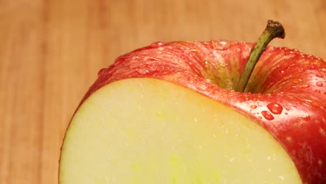 Very-sharp-knife-cuts-a-slice-out-of-a-red-apple,-macro-shot