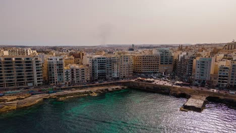 Time-lapse-aerial-view-of-Sliemaâ€™s-waterfront-with-traffick-on-a-beautiful-summer-day-before-sunset