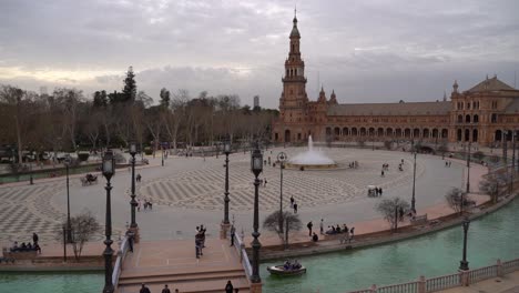 Panoramic-pan-over-Plaza-de-Espana-with-water-fountain-and-people-walking