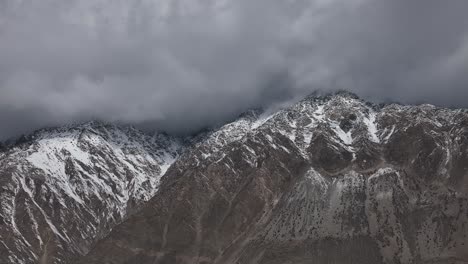 Ominous-Clouds-Above-Peaks-Of-Snow-Covered-Mountains-In-Hunza,-Pakistan