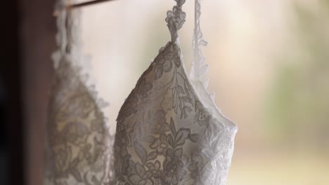 Close-up-of-a-elegant-wedding-dress-hanging-outside-on-a-fall-day-as-bride-prep-for-a-wedding-ceremony