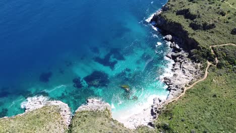 Stunning-bay-with-crystal-clear-turquoise-water-at-Zingaro-on-the-island-of-Sicily-in-Italy,-sunny-weather