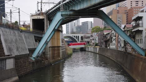 Trains-crossing-Kanda-river-from-Ochanomizu-Station,-Tokyo