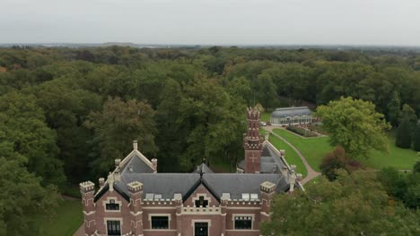 Drone-Volando-Hacia-Atrás-Y-Revela-El-Castillo-Schaffelaar-En-Barneveld,-Países-Bajos