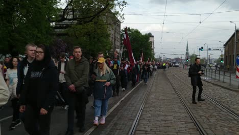 Crowd-of-People-March-in-Streets-of-Riga,-Against-Soviet-Monument