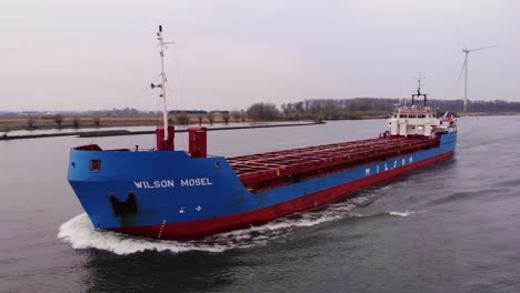 Aerial-Flying-In-Front-Of-Forward-Bow-Of-Wilson-Mosel-Ship-Along-Oude-Maas-On-Overcast-Day-With-Circle-Dolly-left
