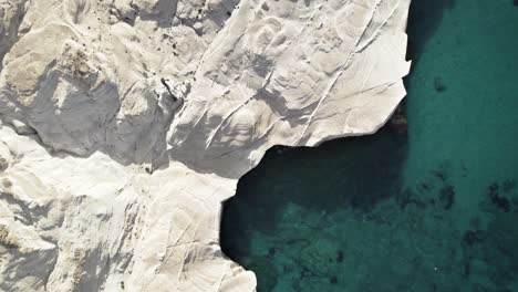 Bright-white-rocky-cliffs-cast-a-shadow-into-the-crystal-clear-waters-of-the-Mediterranean-Sea