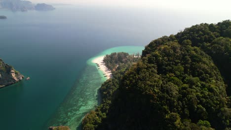 high-altitude-aerial-of-tall-limestone-mountains-on-Ko-Poda-Island-revealing-the-tropical-white-sand-beaches-in-the-Andaman-Sea-of-Krabi-Thailand