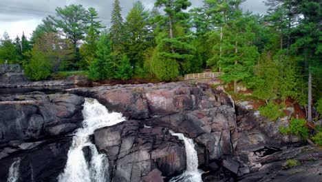 Malerischer-Aussichtspunkt-Im-Wald-Mit-Fließendem-Wasserfall-Und-Felsiger-Böschung