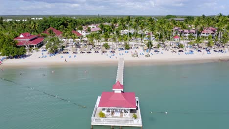 Drone-pov-flying-over-long-pier-and-gazebo-of-Bahia-Principe-Hotel-and-Resort-at-La-Romana,-Dominican-Republic