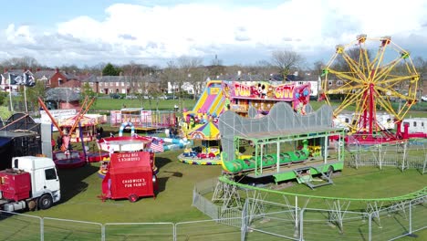Small-town-fairground-Easter-holidays-funfair-rides-in-public-park-aerial-view