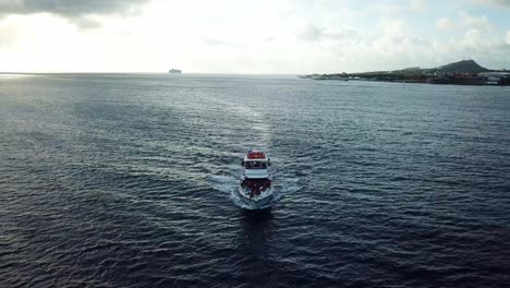 Panoramic-aerial-view-of-a-group-of-black-people-on-a-tourist-yacht-off-the-coast-of-Curacao,-a-Dutch-Caribbean-island