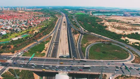 Aerial-of-car-driving-on-the-highways-and-the-city-background-in-the-left-side