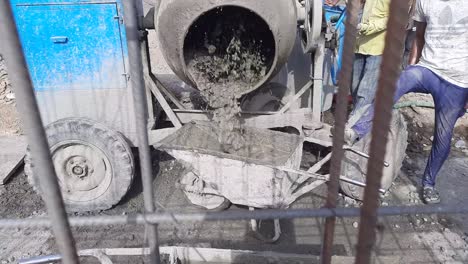 Closeup-view-of-rotating-concrete-mixer-machine-with-concrete-materials