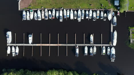 Rows-Of-Sailboats-Docked-In-The-Polder-In-Waterstaete-Ossenzijl,-Netherlands