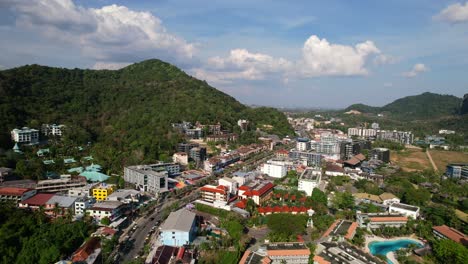 aerial-drone-of-traffic-and-cars-in-Ao-Nang-Krabi-Thailand-surrounded-by-large-mountains-on-a-sunny-summer-day