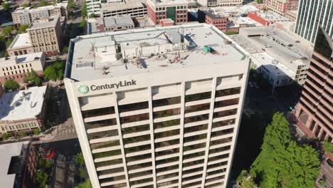 Lowering-tight-aerial-shot-of-CenturyLink-headquarters,-where-internet-is-managed-for-Americans