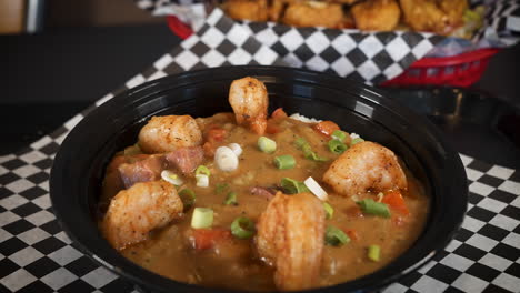 Bowl-of-traditional-shimp-sausage-cajun-etouffee-topped-with-green-onions,-slider-4K