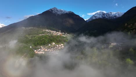 Flight-through-clouds-with-scenic-view-of-Italian-alp-village-in-hillside