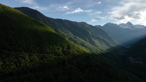 Rays-of-sunlight-glowing-on-lush-green-Italian-alp-valley-hillside