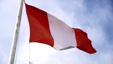 Peruvian-Flag-waving-on-a-windy-day-in-daytime,-up-close-blue-skies