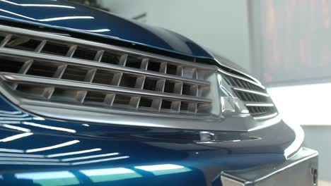 Close-Up-View-Across-Front-Grill-Of-Mitsubishi-Saloon-Car-In-Show-Room