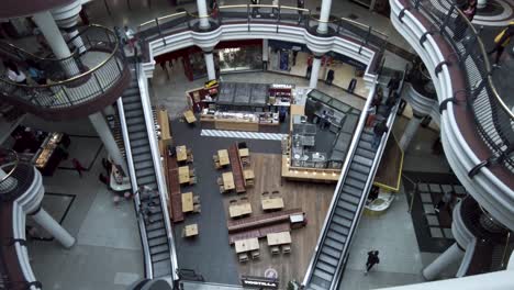 Looking-Down-At-People-Using-Escalators-Inside-St-Georges-Shopping-Centre-In-Harrow-In-Between-Food-Court-On-15-May-2022
