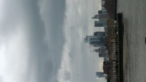City-of-London-Skyline-Viewed-From-Canary-Wharf-Promenade,-London-On-Cloudy-Day