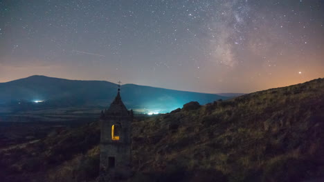 One-of-the-last-milky-way-of-the-season-setting-behind-and-abandoned-old-monasteryÂ´s-tower-bell-in-Avila,-Spain