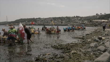 Local-business-teams-starting-at-the-Newlyn-raft-race-charity-fun-outdoors-event,-Cornwall