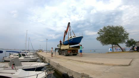 Lifting-boat-from-the-sea-with-crane-on-a-truck