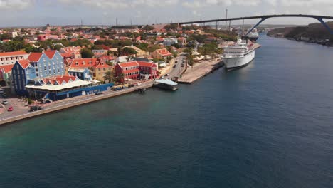 Amazing-aerial-of-a-cruise-ship-docked-in-Sint-Anna-Bay-Willemstad,-Curacao