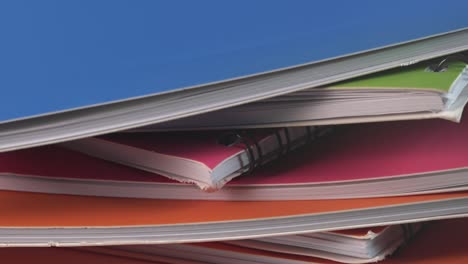 Close-Shot-of-Different-Colored-Notebooks-Rotating