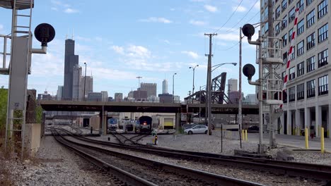 train-leaving-rail-yard-city-skyline-4k