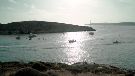 Boats-and-yachts-at-the-entrance-of-a-harbour-in-island-of-Comino,-Malta
