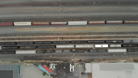 Top-Down-Aerial-of-Train-Cars-Parked-in-Railway-Station