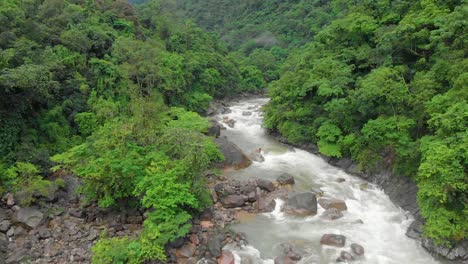 4k-Aerial-Flying-Backward-shot-of-a-River-Stream-in-the-forests-of-Khasihills,-Cheerapunji,-Meghalaya,-India