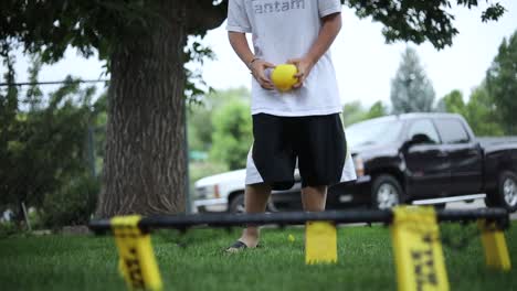 A-group-of-kids-are-playing-the-game-Spikeball-by-hitting-the-small-yellow-ball-onto-the-net