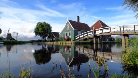 Cheese-factory-building-at-Zaanse-Schans-reflected-on-the-calm-canal-water,-in-Zaandam,-Neterlands