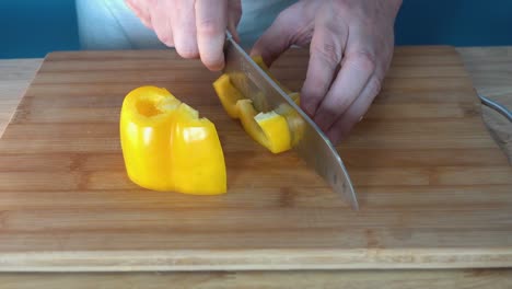 Männlicher-Koch,-Der-Eine-Frische-Gelbe-Paprika-Hackt