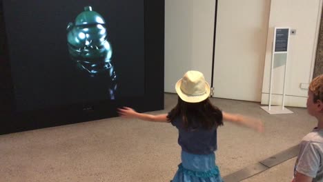 AI-Robot-on-screen-follows-human-moves-at-the-'AI:-More-than-Human'-exhibition,-Barbican